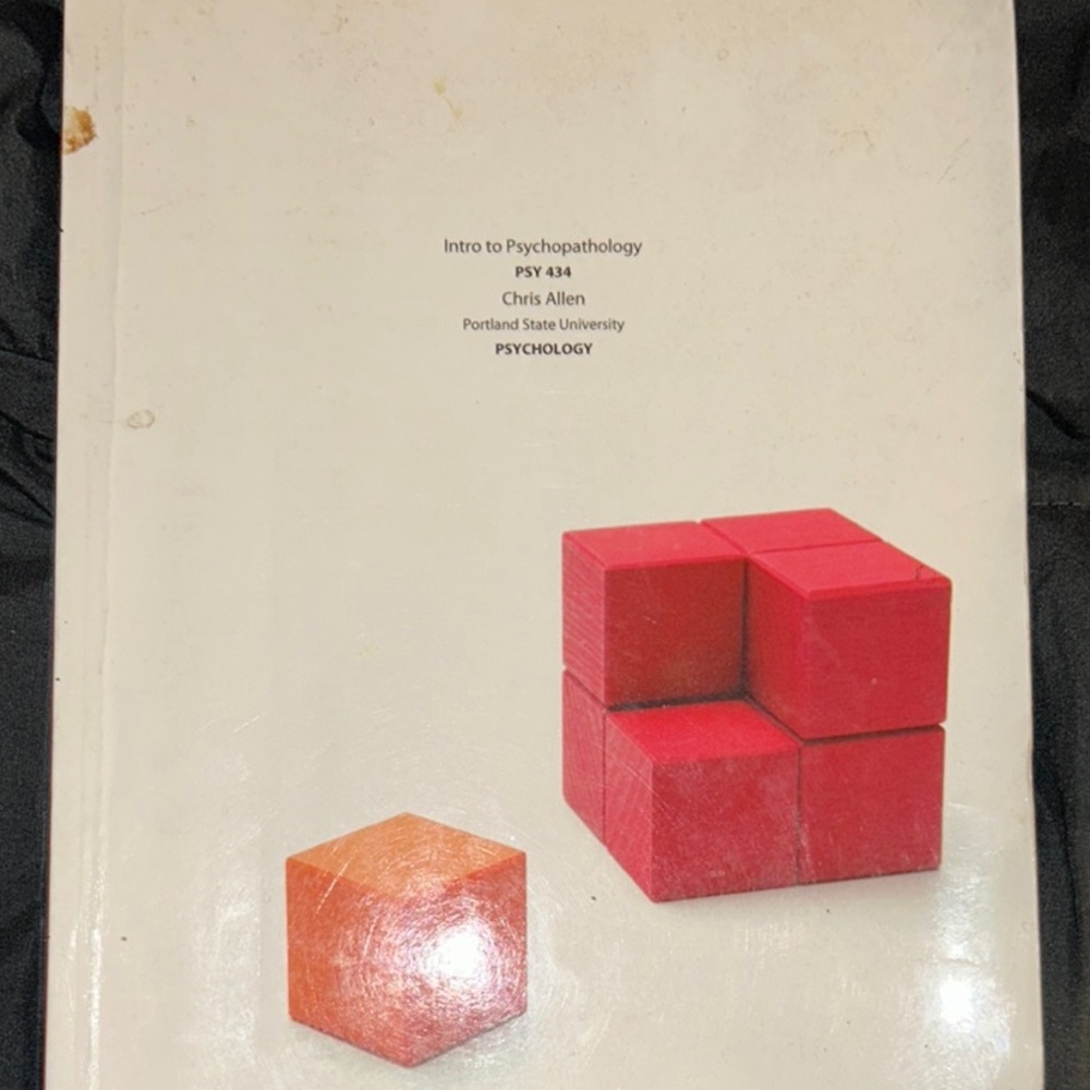 Intro to Psychopathology Textbook with Red and Orange Cover